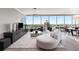 Modern living room with chic furniture and a wall of windows offering city views at 3630 Peachtree Ne Rd # 3207, Atlanta, GA 30326