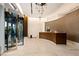 Elegant lobby featuring a curved reception desk, modern lighting fixtures, and a revolving door at 3630 Peachtree Ne Rd # 3207, Atlanta, GA 30326
