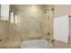 Luxurious walk-in shower featuring beige tile, glass enclosure, and a convenient built-in bench at 3630 Peachtree Ne Rd # 3207, Atlanta, GA 30326