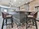Finished basement wet bar with seating, brick accent wall, cabinets and designer touches at 716 Crimson Morning Vw, Canton, GA 30114