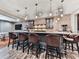 Finished basement bar with brick accent wall, cabinets, stainless appliances, and seating for six at 716 Crimson Morning Vw, Canton, GA 30114