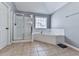 Bathroom showcasing a glass enclosed shower, a garden tub, and a window at 716 Crimson Morning Vw, Canton, GA 30114