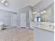 Bright bathroom with tile floor, double doors, and dual sink vanity at 716 Crimson Morning Vw, Canton, GA 30114