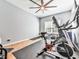 Neutral bonus room with exercise equipment, wood-look floors, ceiling fan, and natural light at 716 Crimson Morning Vw, Canton, GA 30114