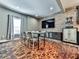 Finished basement dining room and wet bar area with brick accent wall and tv at 716 Crimson Morning Vw, Canton, GA 30114