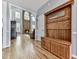 Hallway featuring wood floors, coat rack, and living room with stone fireplace at 716 Crimson Morning Vw, Canton, GA 30114