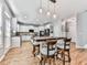 Eat-in kitchen with white cabinets, pendant lighting, and stainless appliances is open to the living room at 716 Crimson Morning Vw, Canton, GA 30114