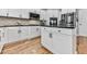 A bright kitchen features white cabinetry, stainless appliances, and a center island with granite countertop at 716 Crimson Morning Vw, Canton, GA 30114