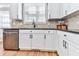Close-up of the kitchen features modern appliances, white cabinets and a view to the exterior at 716 Crimson Morning Vw, Canton, GA 30114