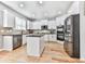 The updated kitchen features stainless appliances, granite countertops, and bright white cabinets at 716 Crimson Morning Vw, Canton, GA 30114