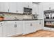 Bright kitchen features white cabinetry, dark hardware, stainless appliances, and granite countertops at 716 Crimson Morning Vw, Canton, GA 30114