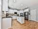 The updated kitchen features white cabinets, a center island, and stainless-steel appliances at 716 Crimson Morning Vw, Canton, GA 30114