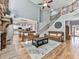 Living room boasts a soaring ceiling, wood floors, access to the staircase, and views into the kitchen at 716 Crimson Morning Vw, Canton, GA 30114