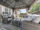 Covered outdoor seating area with wicker furniture, string lights, ceiling fan, and backyard views at 716 Crimson Morning Vw, Canton, GA 30114
