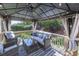 Covered outdoor seating area with wicker furniture, string lights, ceiling fan, and backyard views at 716 Crimson Morning Vw, Canton, GA 30114