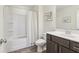 Bright bathroom featuring a shower-tub combo with white tile and a modern vanity at 815 Regal Sw Ln, Atlanta, GA 30331