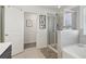 Bathroom with soaking tub, walk-in shower, and neutral tile at 815 Regal Sw Ln, Atlanta, GA 30331