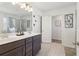 Bathroom with dual sink vanity, tiled floors, and walk-in shower at 815 Regal Sw Ln, Atlanta, GA 30331