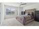 Cozy bedroom with neutral colors, tufted headboard, and ample natural light at 815 Regal Sw Ln, Atlanta, GA 30331
