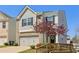 Charming home featuring a two-car garage, manicured lawn, and tree at 815 Regal Sw Ln, Atlanta, GA 30331