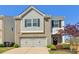 Charming home featuring a two-car garage, manicured lawn, and tree at 815 Regal Sw Ln, Atlanta, GA 30331