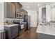 Modern kitchen with stainless steel appliances, counter seating, and stylish backsplash at 815 Regal Sw Ln, Atlanta, GA 30331