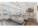 Open-concept living room with large sofa and views of kitchen and dining area at 815 Regal Sw Ln, Atlanta, GA 30331
