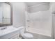 Bright bathroom featuring a tub with shower, toilet, vanity and decorative mirror at 1137 Liberty Nw Pkwy, Atlanta, GA 30318