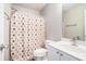 Cozy bathroom with floral shower curtain, a toilet and a sink vanity at 1137 Liberty Nw Pkwy, Atlanta, GA 30318