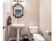 Well-lit powder room with a pedestal sink and decorative mirror at 1137 Liberty Nw Pkwy, Atlanta, GA 30318