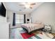 Cozy bedroom with a ceiling fan, neutral colors, and large window providing natural light at 1137 Liberty Nw Pkwy, Atlanta, GA 30318