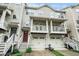 Charming townhome exterior with dual front porches and garages, showcasing inviting curb appeal at 1137 Liberty Nw Pkwy, Atlanta, GA 30318