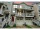 Townhome featuring a garage, covered porch, and upstairs balcony at 1137 Liberty Nw Pkwy, Atlanta, GA 30318