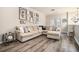 Spacious living room features a large sectional sofa, hardwood floors, and stylish wall art at 1137 Liberty Nw Pkwy, Atlanta, GA 30318