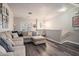 Open-concept living room featuring a plush sectional, hardwood floors, and contemporary decor at 1137 Liberty Nw Pkwy, Atlanta, GA 30318