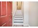 Bright staircase leading to the upper level, with white risers and a red front door at 1137 Liberty Nw Pkwy, Atlanta, GA 30318