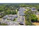 An aerial view showcases the neighborhood of townhomes with tree-lined streets in a beautiful community at 2004 Cortland Rd, Milton, GA 30009