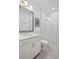 Modern bathroom with glass shower, grey tile floors, and white cabinets for storage at 2004 Cortland Rd, Milton, GA 30009