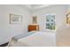 Bright bedroom features a white bed, wooden dresser, and a window with a view at 2004 Cortland Rd, Milton, GA 30009
