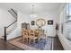 Bright dining room with a chandelier, staircase, and light-filled windows, perfect for gatherings and special occasions at 2004 Cortland Rd, Milton, GA 30009