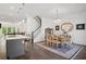 Bright dining area with hardwood floors, staircase, chandelier, and island in an open floor plan at 2004 Cortland Rd, Milton, GA 30009