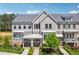 Beautiful townhome with gray siding, a gray roof, and manicured landscaping showcasing its curb appeal at 2004 Cortland Rd, Milton, GA 30009