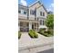 Charming townhome facade with symmetrical landscaping leading to inviting, covered front doors and walkway at 2004 Cortland Rd, Milton, GA 30009