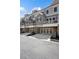 Modern townhomes with basement garages and balconies on a tree-lined street at 2004 Cortland Rd, Milton, GA 30009
