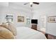 Bright main bedroom with tray ceiling, windows, tv, and ensuite bath with glass shower at 2004 Cortland Rd, Milton, GA 30009