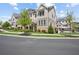 Well-manicured neighborhood with modern townhomes and tidy front lawns under a blue sky at 2004 Cortland Rd, Milton, GA 30009