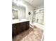 Bathroom featuring a vanity with drawers, a built-in mirror, and a shower-tub combo at 2101 Adams Acres Dr, Lawrenceville, GA 30043