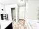Bright bathroom with tiled floors, black accents, and an open doorway to the toilet at 2101 Adams Acres Dr, Lawrenceville, GA 30043