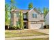Charming home with a two-car garage, lush lawn, and a mix of brick and siding exterior at 2101 Adams Acres Dr, Lawrenceville, GA 30043