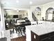 Open-concept kitchen with granite island, stainless appliances, open to living and dining areas at 2101 Adams Acres Dr, Lawrenceville, GA 30043